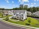 Aerial view of a two-story white home with landscaped yard, showcasing its place in a friendly neighborhood at 6080 Simone St, Acworth, GA 30101