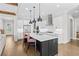 Bright open kitchen with black island, stainless appliances, and a seamless flow to the living area at 6080 Simone St, Acworth, GA 30101