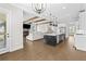 Bright open-concept kitchen boasts a black island, stainless appliances, and seamless flow to living area at 6080 Simone St, Acworth, GA 30101