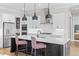 Modern open kitchen features a black island, stainless appliances, and seamless flow into the living area at 6080 Simone St, Acworth, GA 30101