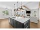 Modern kitchen island with sink, stainless appliances and view of living room at 6080 Simone St, Acworth, GA 30101