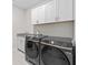 The laundry room features black appliances, granite counters, and white cabinets at 6080 Simone St, Acworth, GA 30101