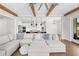 Open living space with the kitchen view, hardwood floors, and wood beam ceilings creating a warm atmosphere at 6080 Simone St, Acworth, GA 30101