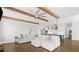 Open living room with wood beam ceiling, large sectional sofa and seamless flow to the kitchen at 6080 Simone St, Acworth, GA 30101