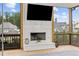 A cozy screened-in patio features a fireplace, TV, and wood flooring at 6080 Simone St, Acworth, GA 30101