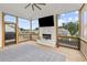 A screened-in patio equipped with a fireplace, TV, and wooden flooring at 6080 Simone St, Acworth, GA 30101