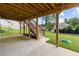 Covered patio area, with stairs leading to the upper deck and backyard at 6080 Simone St, Acworth, GA 30101