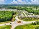 Wide aerial view showcasing community layout with homes, clubhouse, and surrounding landscape at 1802 Lexington Green Pnes, Cumming, GA 30040