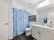 Bright bathroom features a single vanity, framed mirror, and a fun shark-themed shower curtain at 1802 Lexington Green Pnes, Cumming, GA 30040