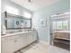 Spacious bathroom featuring dual sinks, a large mirror, and tile flooring with a view of the bedroom at 1802 Lexington Green Pnes, Cumming, GA 30040
