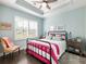 Bedroom with a vibrant color scheme, comfortable sitting chair, and a large window with shutters at 1802 Lexington Green Pnes, Cumming, GA 30040