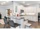 Bright kitchen features white cabinets, stainless steel appliances, and a stylish breakfast bar with seating at 1802 Lexington Green Pnes, Cumming, GA 30040