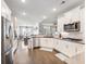Updated kitchen showcases sleek stainless steel appliances, white cabinetry and modern finishes, enhancing appeal at 1802 Lexington Green Pnes, Cumming, GA 30040