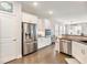 Spacious kitchen with stainless steel refrigerator, built-in oven, and open layout is perfect for entertaining at 1802 Lexington Green Pnes, Cumming, GA 30040