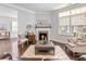 Cozy living room with a fireplace, bright windows, and comfortable seating arrangements at 1802 Lexington Green Pnes, Cumming, GA 30040