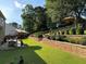 Outdoor dining and lounge area with an expansive terraced backyard and lush greenery at 2380 Cain Cir, Dacula, GA 30019