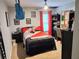 A bright bedroom features a single bed with colorful accents, a ceiling fan, and accessories, plus a desk for doing homework at 2380 Cain Cir, Dacula, GA 30019
