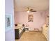 This cozy bedroom features pink walls, a ceiling fan, carpet flooring, and a single bed with butterfly bedding at 2380 Cain Cir, Dacula, GA 30019