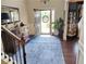 Welcoming entryway with hardwood floors, a staircase, and natural light streaming through the front door at 2380 Cain Cir, Dacula, GA 30019