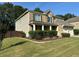 Charming two-story home boasts a well-manicured lawn and inviting curb appeal with manicured shrubbery at 2380 Cain Cir, Dacula, GA 30019
