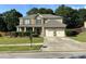 Inviting two-story home with a two car garage and well-maintained front lawn with landscaped garden at 2380 Cain Cir, Dacula, GA 30019
