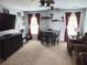 Inviting living room with a large TV, piano, comfortable seating, carpet flooring, and good natural light at 2380 Cain Cir, Dacula, GA 30019