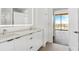 Stylish bathroom featuring a double vanity, modern fixtures, and a glimpse of the city view at 788 W Marietta Nw St # 1404, Atlanta, GA 30318