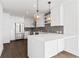 Airy kitchen features a large white island, stainless steel appliances, and modern pendant lighting at 788 W Marietta Nw St # 1404, Atlanta, GA 30318