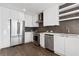 Bright kitchen showcasing white cabinets, stainless steel appliances, and sleek open shelving at 788 W Marietta Nw St # 1404, Atlanta, GA 30318