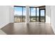 Open living room featuring floor-to-ceiling windows and a view of the cityscape at 788 W Marietta Nw St # 1404, Atlanta, GA 30318