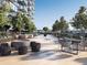Luxury rooftop terrace boasts contemporary outdoor seating, lush landscaping, and a firepit with city views at 788 W Marietta Nw St # 1404, Atlanta, GA 30318