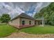 Back of house featuring large yard and patio with columns at 9187 Plantation Cir, Covington, GA 30014