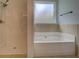 Bathroom featuring a tiled shower and soaking tub, creating a spa-like experience at 9187 Plantation Cir, Covington, GA 30014