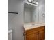 Bathroom vanity featuring wood cabinets and a decorative lighting fixture above the mirror at 9187 Plantation Cir, Covington, GA 30014