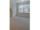Carpeted bedroom featuring a large window that provides natural light and neighborhood views at 9187 Plantation Cir, Covington, GA 30014
