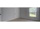 Bright bedroom with carpet, window, and paneled door; ideal for relaxing and sleeping at 9187 Plantation Cir, Covington, GA 30014