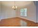 Elegant dining room with hardwood floors, wainscoting, and a chandelier at 9187 Plantation Cir, Covington, GA 30014
