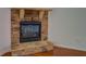 Cozy stone fireplace with raised hearth, complemented by hardwood floors, enhancing the living space at 9187 Plantation Cir, Covington, GA 30014