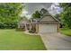 Charming brick home featuring a well-manicured lawn, two car garage, and welcoming walkway at 9187 Plantation Cir, Covington, GA 30014