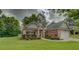 Beautiful brick home showcasing a lush green lawn and lovely front yard landscaping at 9187 Plantation Cir, Covington, GA 30014