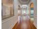 Hallway with arches, molding, wood floors, and elegant lighting at 9187 Plantation Cir, Covington, GA 30014
