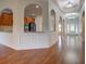 Spacious hallway with hardwood floors and architectural details leads to living areas and kitchen at 9187 Plantation Cir, Covington, GA 30014