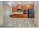 Bright kitchen with wooden cabinets, granite countertops and modern stainless steel appliances at 9187 Plantation Cir, Covington, GA 30014