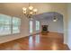 Open living room with hardwood floors, vaulted ceilings, and view of the fireplace at 9187 Plantation Cir, Covington, GA 30014