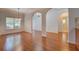 Bright living room featuring hardwood floors, decorative trim, and a view of the front entrance at 9187 Plantation Cir, Covington, GA 30014