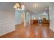 Open floor plan with hardwood floors connects living area to kitchen with modern appliances at 9187 Plantation Cir, Covington, GA 30014