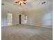 Large main bedroom featuring a ceiling fan, carpet, and connecting doorway to bath at 9187 Plantation Cir, Covington, GA 30014