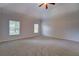Expansive main bedroom with carpet, vaulted ceiling, and multiple windows for natural light at 9187 Plantation Cir, Covington, GA 30014
