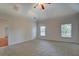 Spacious bedroom with carpet, ceiling fan, and large windows for natural light at 9187 Plantation Cir, Covington, GA 30014