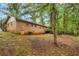 Backyard featuring a brick house, wooden deck, mature trees and a large grassy area at 1513 Dupree Rd, Woodstock, GA 30189